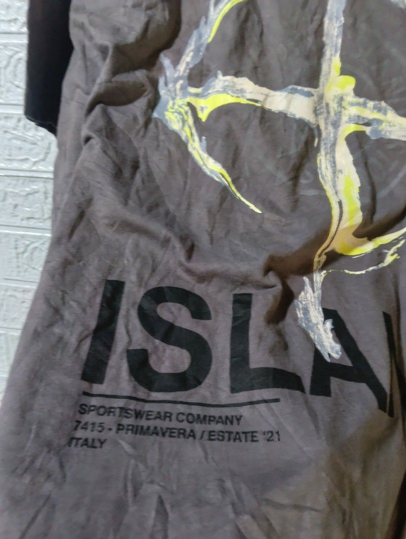 Stone Island Back Graphic T-Shirt (Category: Tshirts & Polo Shirts ) located in Davao. Submitted by noelamihan05424 (Listing ID 1470407014, Image 3). Description: - Brand: Stone Island - Color: Grey - Fit: Simple relaxed fit - Material: Comfortable cotton - Details: Small logo on chest, striped inner neck taping - Back Graphic: Large distressed compass with bold text including 'Sportswear Company Primavera Estate 21 Italy' - Condition: Grab it wh