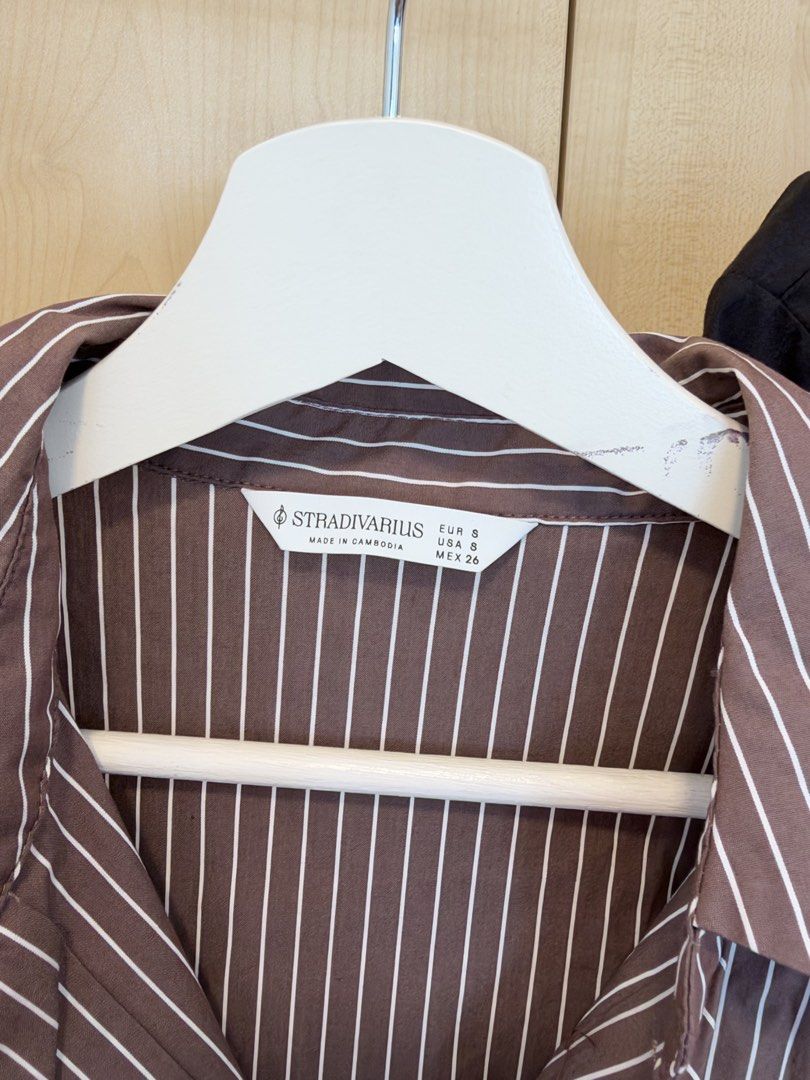 Stradivarius Brown Striped and Black Button-Up Shirts Size S (Category: Shirts) located in Makati City. Submitted by itsmeann09 (Listing ID 1470393049, Image 2). Description: sold by bundle of 2 - Brand: Stradivarius - Quantity: Set of 2 shirts - Size: S (EUR/USA/MEX sizing) - Colors/Patterns: Brown with white vertical stripes, and solid black - Design: Classic lapel collars and long sleeves - Style: Versatile for work or casual days.