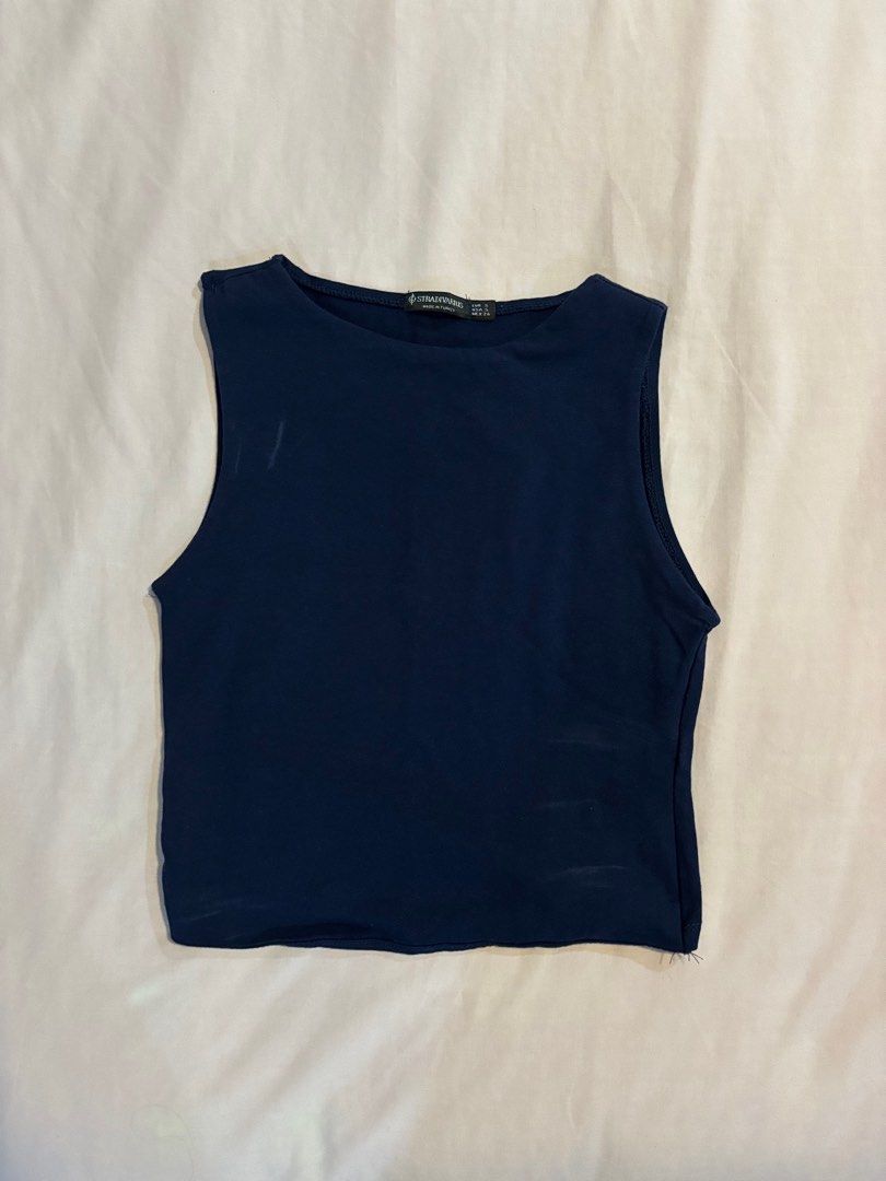 Stradivarius Dark Blue Sleeveless Top (Category: Sleeveless) located in Quezon City. Submitted by cmtom (Listing ID 1470368940, Image 1). Description: Loc: qc Dark blue boatneck tank top from Stradivarius, bought in 2022/2023. Fabric is stretchy and comfortable Best fits size XS-S and people with narrower shoulders (the armpit part folds awkwardly on me as i have broader shoulders) Has some detergent stains (which are removable with handwashing) 