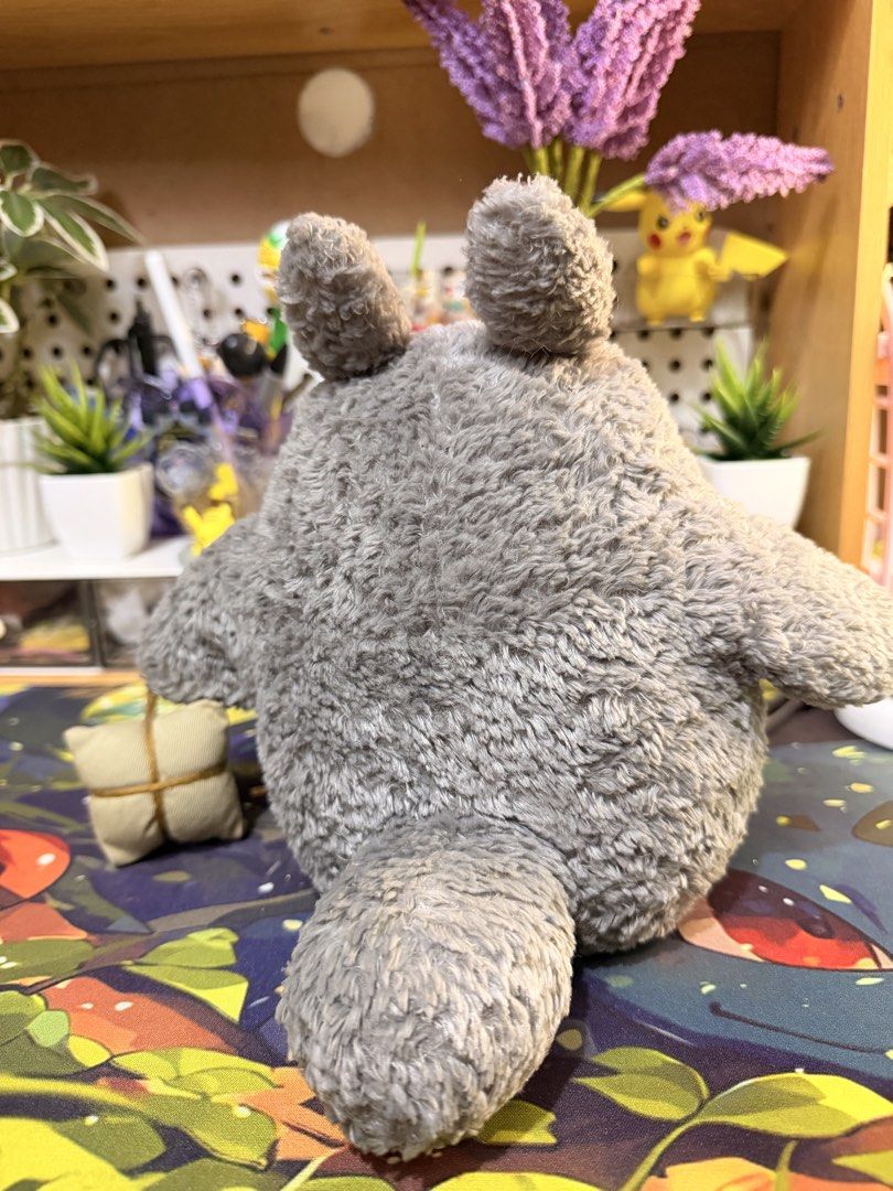Studio Ghibli Totoro (Category: Plushies & Soft Toys) located in Baguio. Submitted by jonathanseller_buyer (Listing ID 1470514219, Image 3). Description: - Authentic Totoro plush with official tag attached - Features soft grey and white fur with classic belly markings - Holds an adorable small tied pouch - Clean and well-cared for condition - Perfect display piece for anime fans and collectors.