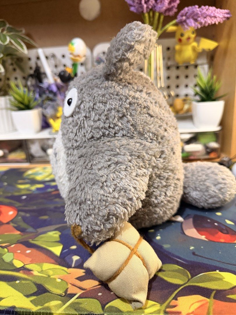 Studio Ghibli Totoro (Category: Plushies & Soft Toys) located in Baguio. Submitted by jonathanseller_buyer (Listing ID 1470514219, Image 2). Description: - Authentic Totoro plush with official tag attached - Features soft grey and white fur with classic belly markings - Holds an adorable small tied pouch - Clean and well-cared for condition - Perfect display piece for anime fans and collectors.