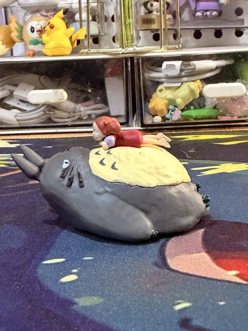 Studio Ghibli Totoro figurine (Category: Figurines & Statues) located in Baguio. Submitted by jonathanseller_buyer (Listing ID 1470513341, Image 1). Description: - Official Studio Ghibli merchandise with copyright stamp on the bottom - Features Grey Totoro with a cream-colored belly and a small character lying on top - Detailed paws with green accents - Stands flat, perfect for desktop display - Great gift for Totoro fans and collectors.