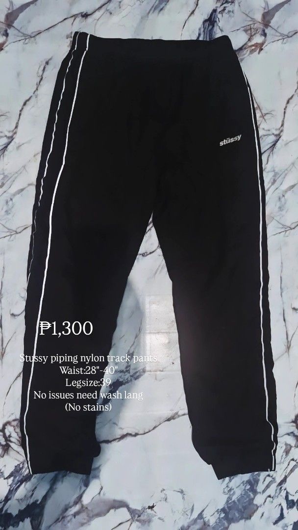 Stussy piping nylon track pants (Category: Joggers) located in Baguio. Submitted by kali_diego074 (Listing ID 1470366065, Image 1). Description: - Brand: Stussy - Item: Piping nylon track pants - Color: Black with white side piping and logo - Size: Small (S) - Waist: Stretches from 28 to 40 inches - Length: 39 inches - Condition: No stains or issues, just needs a wash.