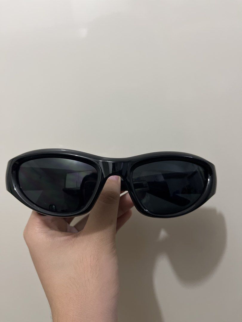 Sunglasses (Category: Sunglasses & Eyewear) located in Manila. Submitted by beabeep (Listing ID 1470464547, Image 3). Description: - Bundle includes 2 pairs of sunglasses - Pair 1: Bold white frame with a large reflective mirror shield lens - Pair 2: Classic black wrap-around frame with dark tinted lenses - Condition: Clean shape with no obvious scratches on the lenses - used once - from orange app.