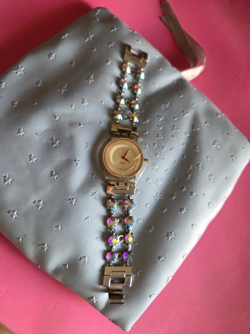 Swatch Rhinestone Bracelet Watch (Category: Women's Watches) located in Pasig City. Submitted by tatashki (Listing ID 1470375785, Image 1). Description: - Authentic 2002 Swatch Swiss quartz watch - Selling as is Crack on the face , bracelet no issues , can be used for other swatch - Silver-tone double chain bracelet embedded with sparkling iridescent rhinestones - Secure clasp closure stamped with the iconic Swatch logo - Transparent case back sh