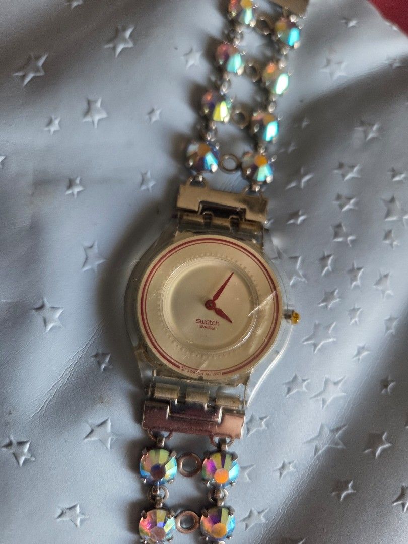 Swatch Rhinestone Bracelet Watch (Category: Women's Watches) located in Pasig City. Submitted by tatashki (Listing ID 1470375785, Image 2). Description: - Authentic 2002 Swatch Swiss quartz watch - Selling as is Crack on the face , bracelet no issues , can be used for other swatch - Silver-tone double chain bracelet embedded with sparkling iridescent rhinestones - Secure clasp closure stamped with the iconic Swatch logo - Transparent case back sh
