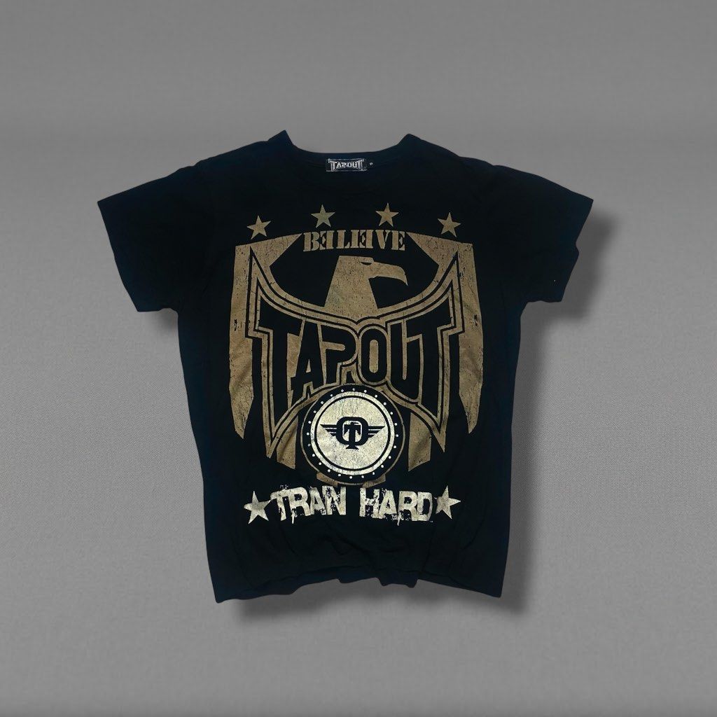 Tapout Graphic T-Shirt Size S (Category: Tshirts & Polo Shirts ) located in Camiling. Submitted by camthrift_2024 (Listing ID 1470395801, Image 1). Description: TAPOUT TEE MEDIUM 20x25 COLOR RATE: 10/10 ISSUE:❌❌❌ ₱200 PEDE VC SA JNT SHIP NOW OPEN FOR TERMS UNLI VOUCH GCASH JNT CAMILING, TARLAC📌 - Brand: Tapout - Color: Black - Size: Small (tagged at collar) - Design: Large eagle and logo graphic on front with 'BELIEVE', 'TRAN HARD', and star det