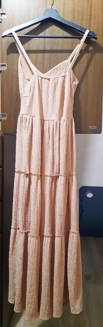 Taupe Spaghetti Strap Tiered Maxi Dress (Category: Dresses) located in Manila. Submitted by gracjam_27 (Listing ID 1470538119, Image 2). Description: - Color: Peach pink - Design: V-neckline with double spaghetti straps and a straight back - Fit: Fitted bodice with a tiered, flowy skirt and subtle ruffle details - Fabric: Lightweight material with a crinkled texture throughout - Occasion: Ideal for casual outings, beach days, and weekend hangouts