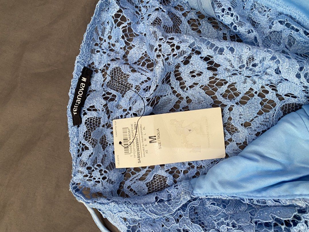 Terranova Blue Lace Cami Top (Category: Sleeveless) located in Dasmarinas. Submitted by closetcleanser_ (Listing ID 1470430578, Image 3). Description: - Brand: Terranova - Size: Medium - Color: Light blue - Design: V-neckline, spaghetti straps, side zipper closure - Details: Fully lined with a delicate floral lace overlay - Condition: Brand new with original store tags attached.