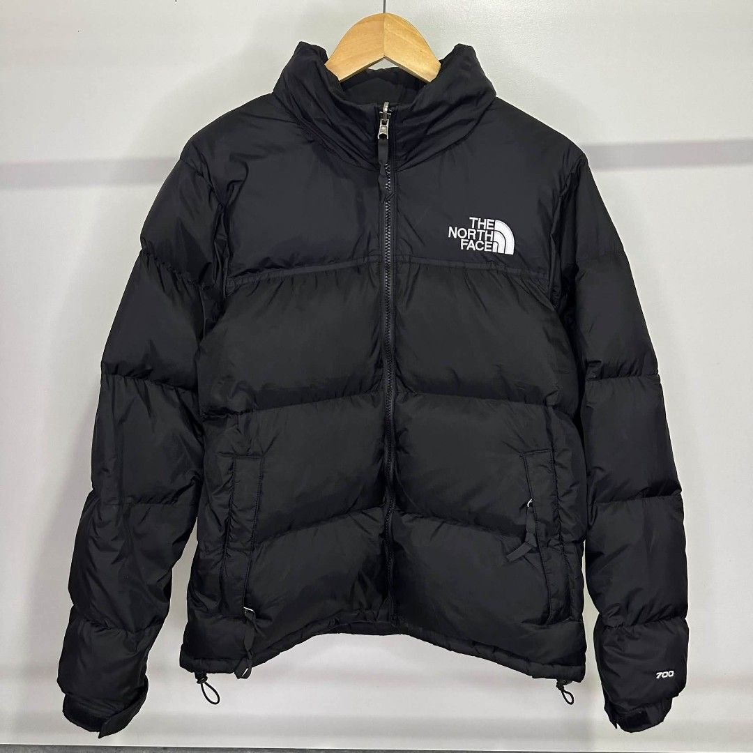 The North Face 700 Nuptse Puffer Jacket Black (Category: Coats, Jackets and Outerwear) located in Manila. Submitted by ggclothings (Listing ID 1470491080, Image 1). Description: - Authentic The North Face 700 puffer jacket in classic black - 700 fill down insulation for ultimate warmth in cold weather - Full zip front with a high collar and zippered side pockets - Features embroidered white chest logo and 700 sleeve cuff embroidery - Adjustable h