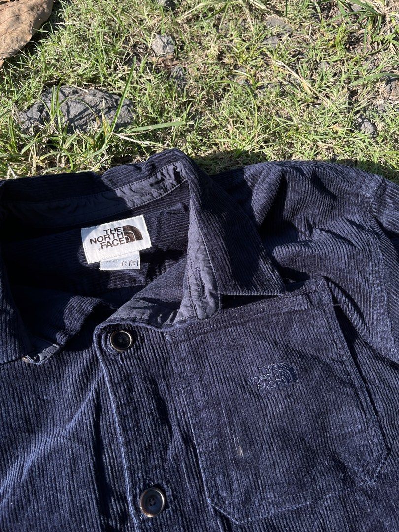 The North Face Corduroy Button-Up Jacket Navy Blue (Category: Coats, Jackets and Outerwear) located in Manila. Submitted by raphaelmercado. (Listing ID 1470420219, Image 1). Description: - Brand: The North Face - Style: Dark navy blue corduroy jacket with classic button-up front and pointy collar - Details: Single chest pocket with embroidered logo, thick ribbed texture - Size: L - Condition: Clean, no stains or holes - Perfect for: Great layerin