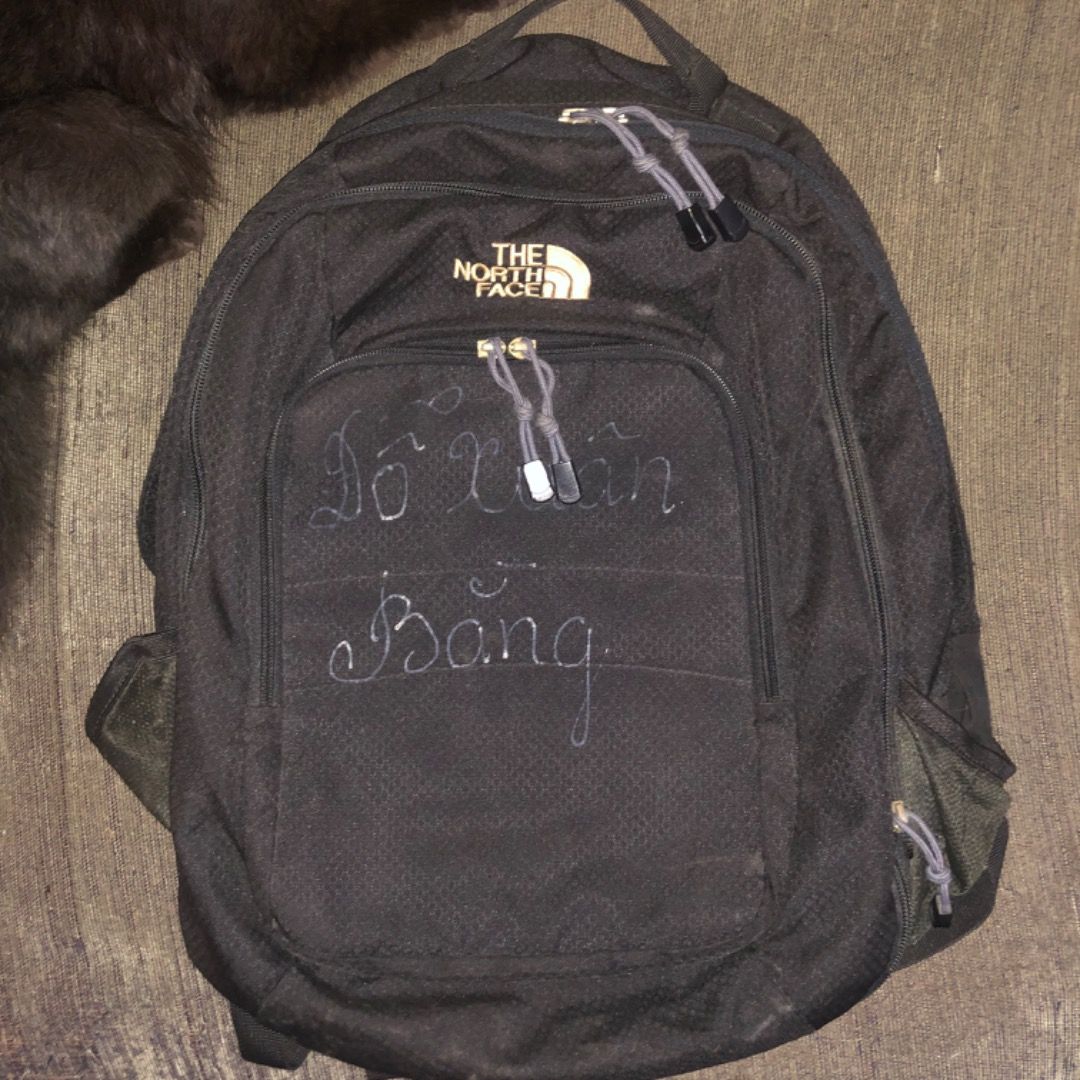 The North Face Jester backpack (Category: Backpacks) located in Mandaluyong City. Submitted by philbert420 (Listing ID 1470542927, Image 1). Description: - Brand: The North Face - Color: Black with grey zipper pulls - Features: Multiple zippered compartments, dual side pockets, sturdy top handle, and adjustable shoulder straps - Flaws: Visible signs of previous use and wear all over, plus handwritten text on the front pocket - Condition: Well-use