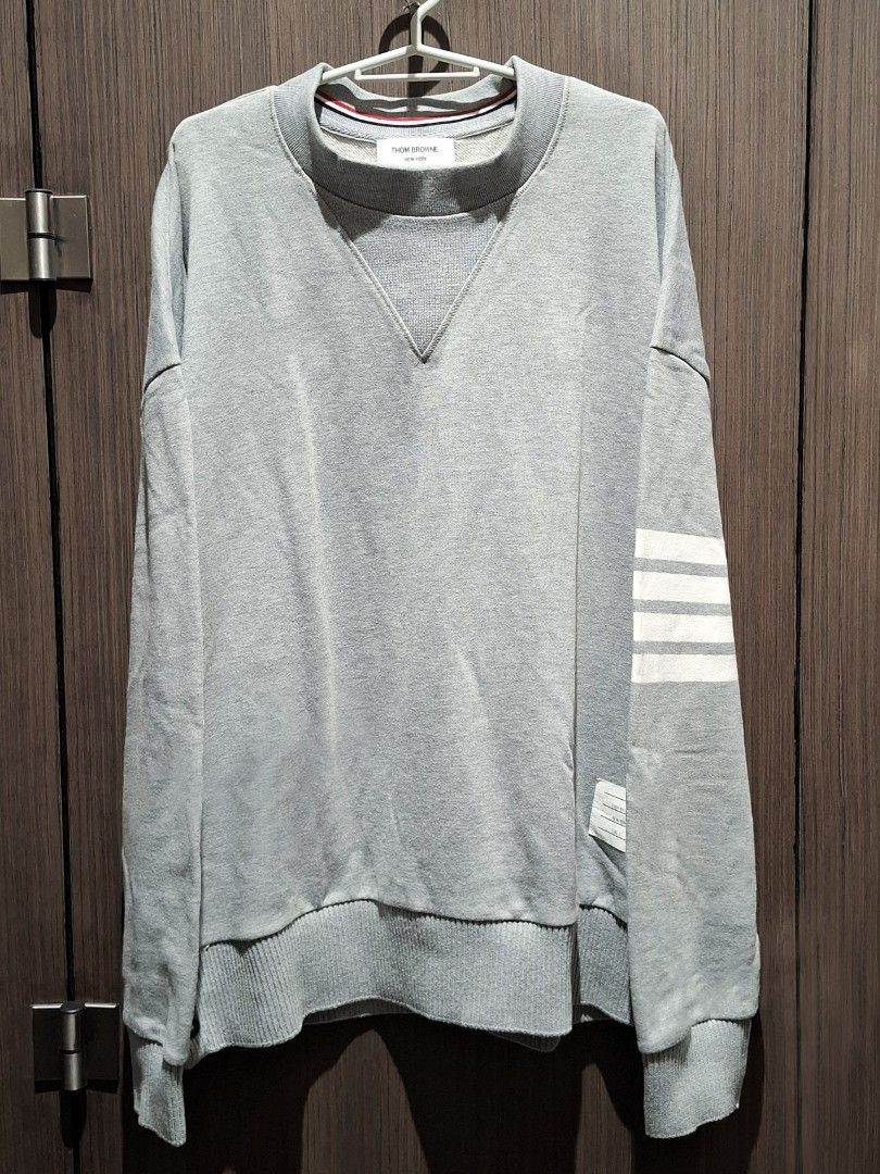 Thom Browne Grey 4-Bar Oversized Classic Sweatshirt (Guaranteed Authentic) (Category: Coats, Jackets and Outerwear) located in Pasig City. Submitted by coveted.mnl (Listing ID 1470469130, Image 1). Description: Guaranteed Authentic📌 In Pristine Condition🤍 W/ extra button~ Best fit to: Xl Width : 25 Length : 28 (MEASURED BY INCHES) 9.5/10 overall condition No issues or flaws in fabric Retailed for $750 (P47,250) • P 9,000 Slightly negotiable • P