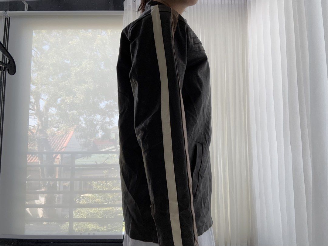 thrifted black & brown leather racer jacket (Category: Coats, Jackets and Outerwear) located in Manila. Submitted by gothclaudia (Listing ID 1470390011, Image 2). Description: RFS: decluttering my closet! :) not my style anymore - originally thrifted from Singapore last May 2025, hasn't been worn since! - heavy duty leather jacket - dark brown or black with beige and tan contrast racing stripes - front zip closure, two zipped chest pockets, and s