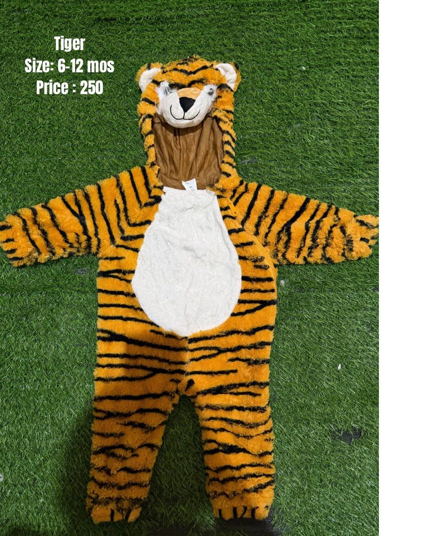 Tiger Costume Size 6-12 Months (Category: Babies & Kids Fashion) located in San Fernando. Submitted by InvisibleMe (Listing ID 1470451113, Image 1). Description: - Size: 6 to 12 months - Design: Orange and black stripes with a white belly and cute hooded tiger face with plush ears - Material: Ultra-soft fabric to keep your little one warm and comfortable - Convenience: Easy front zipper closure for quick and hassle-free changes - Perfect for: Hal