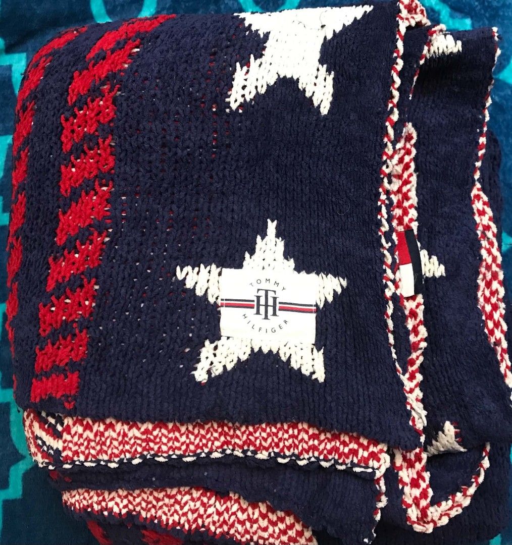 Tommy Hilfiger Knit Star Blanket Single size (Category: Bedding & Towels) located in Imus. Submitted by stop_shop7 (Listing ID 1470359689, Image 3). Description: - Authentic Tommy Hilfiger knit throw blanket - Classic navy blue, red, and white colorway with star patterns - Features red striped borders and iconic flag logo patch - Soft and cozy knit texture, ideal for living room or bedroom - Perfect home decor accessory or gift.