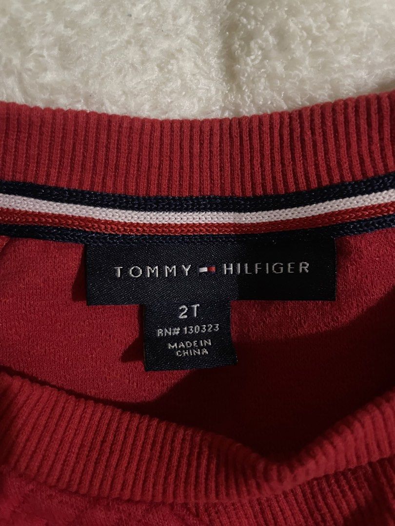 Tommy Hilfiger Red Heart Sweatshirt (Category: Babies & Kids Fashion) located in San Mateo. Submitted by stassiealy (Listing ID 1470498263, Image 3). Description: - Brand: Tommy Hilfiger - Color: Red - Design: Three embroidered hearts with signature branding on the chest - Material: Soft textured knit fabric - Features: Quilted design with ribbed collar, cuffs, and hem - Condition: Excellent pre-loved condition - Perfect for: Casual streetwear an