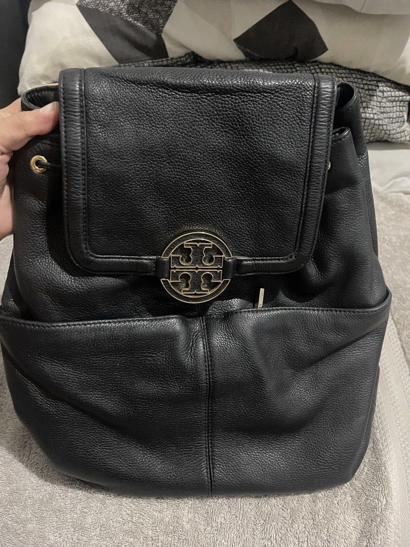 Tory Burch Black Leather Backpack (Category: Backpacks) located in Manila. Submitted by miss.arpee (Listing ID 1470503513, Image 2). Description: - Authentic black pebbled leather backpack - Elegant gold-tone hardware & iconic large front logo plaque - Soft, slouchy structure with convenient exterior slip pockets - Comfortable adjustable shoulder straps & sturdy top handle - Logo-lined interior featuring a secure zippered pocket and metal logo pl