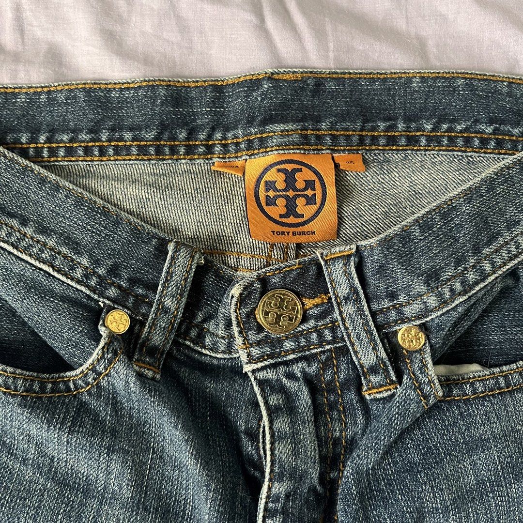 Tory Burch Blue Denim Jeans (Category: Jeans) located in Manila. Submitted by prelovedpick.com (Listing ID 1470404228, Image 1). Description: - Brand: Tory Burch - Size: 25 - Wash: Medium blue with orange contrast stitching - Fit: Bootcut / flare leg silhouette - Details: Branded gold-tone hardware on button and rivets, classic 5-pocket styling - Condition: Great addition to any casual wardrobe.