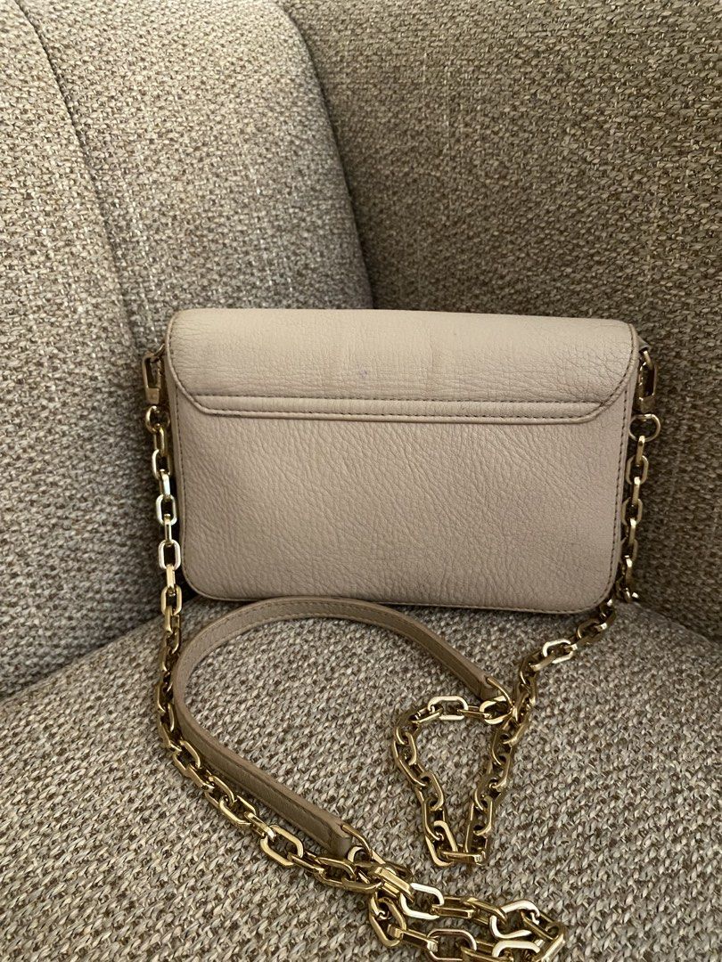 Tory Burch Bombe Mini Flap Beige (Category: Luxury Bags & Wallets) located in Pagadian. Submitted by everbeauxsacs (Listing ID 1470365418, Image 2). Description: - Brand: Tory Burch - Material: Premium beige pebble leather - Hardware: Elegant gold-tone mixed with leather chain strap - Closure: Secure magnetic snap under front flap - Exterior: Chic debossed logo circle on front, convenient back slip pocket - Interior: Monogram fabric lining with a
