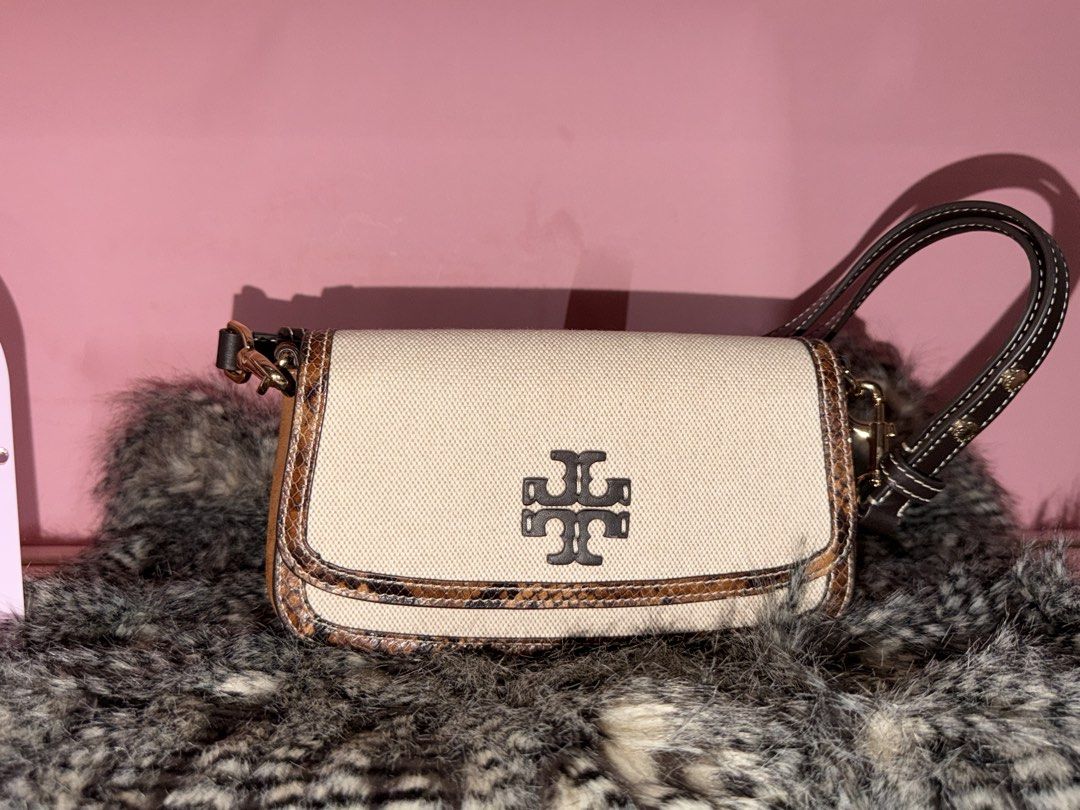 Tory Burch Canvas and Snake Print Shoulder Bag (Category: Shoulder Bags) located in Quezon City. Submitted by parischanelcollection (Listing ID 1470556494, Image 1). Description: - Brand: Tory Burch - Material: Cream canvas with snake print trim and dark brown leather strap - Hardware: Gold-tone clips with prominent double T logo front flap - Interior: Clean chevron-patterned lining with one zippered pocket - Style: Compact, versatile everyday sh