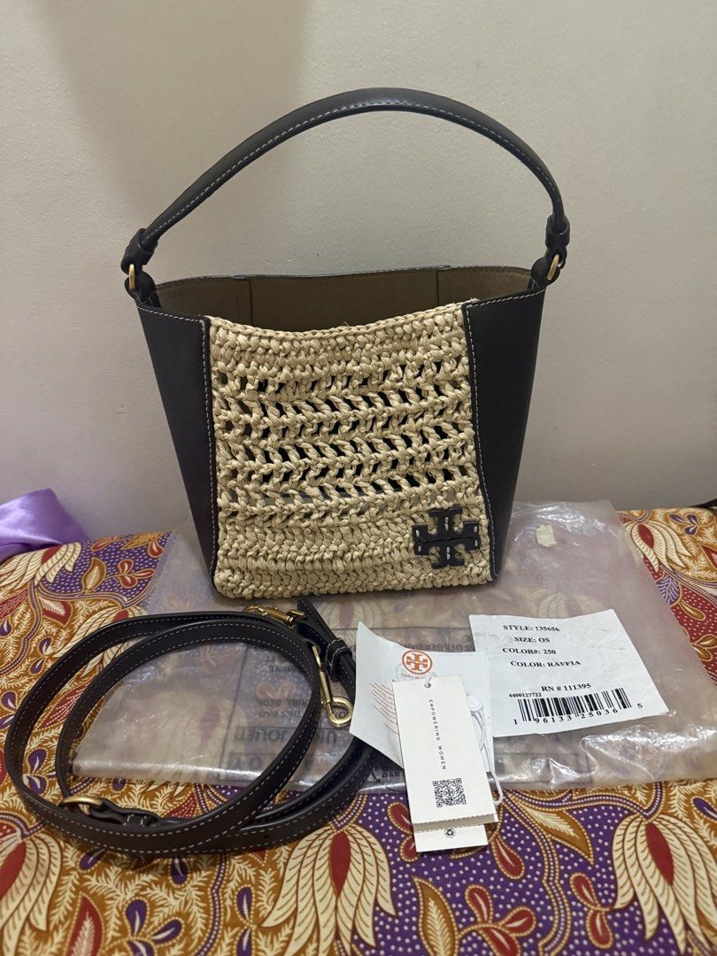 Tory Burch McGraw Raffia Small Bucket Bag (Category: Luxury Bags & Wallets) located in Quezon City. Submitted by msaisa (Listing ID 1470385852, Image 1). Description: - Brand: Tory Burch - Style Number: 135656 (Color: 250 Raffia) - Size: OS - Condition: Brand new with original tags attached - Material: Textured raffia weave with dark leather trim - Includes: Detachable shoulder strap - Design: Structured shape with front Double T logo detail - Va