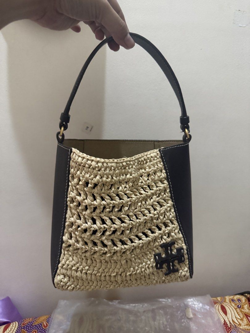 Tory Burch McGraw Raffia Small Bucket Bag (Category: Luxury Bags & Wallets) located in Quezon City. Submitted by msaisa (Listing ID 1470385852, Image 3). Description: - Brand: Tory Burch - Style Number: 135656 (Color: 250 Raffia) - Size: OS - Condition: Brand new with original tags attached - Material: Textured raffia weave with dark leather trim - Includes: Detachable shoulder strap - Design: Structured shape with front Double T logo detail - Va