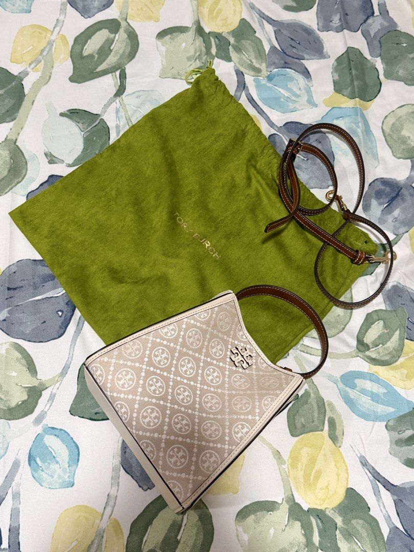 Tory Burch Monogram Jacquard Mini Tote Bag (Category: Tote Bags) located in Paranaque City. Submitted by knipsetah (Listing ID 1470371500, Image 1). Description: - Brand: Tory Burch Mini Tote - Material: Beige monogram jacquard fabric with brown leather trim - Hardware: Silver-tone with front logo plaque - Straps: Brown leather top handles and matching detachable long strap - Details: Structured shape with chic white piping along the edges - Incl