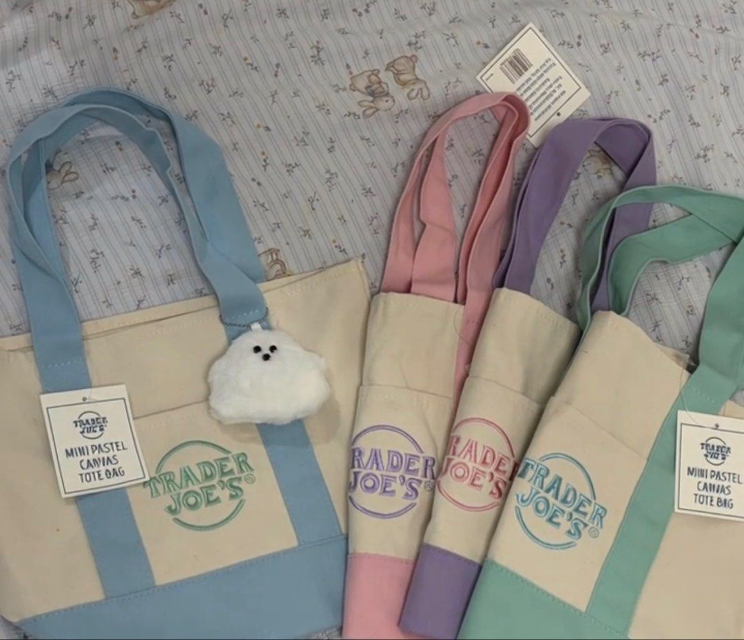Trader Joe's Mini Pastel Canvas Tote Bag (Category: Tote Bags) located in Manila. Submitted by royalpengwen (Listing ID 1470440893, Image 3). Description: - 100% Authentic Trader Joe's Mini Pastel Canvas Tote Bag - Condition: Brand new with tags (BNWT) - Available colors: Pink, Purple, Mint Green, and Blue - Material: Durable, sturdy canvas with contrasting colored straps and bottom panel - Features: Convenient front slip pocket with embroidered 