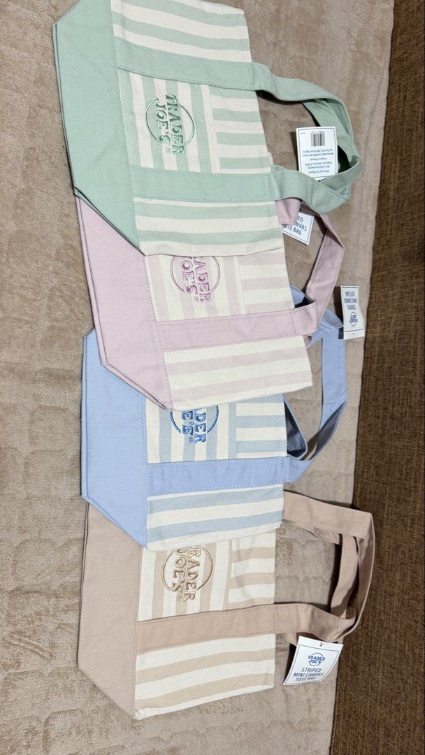 Trader Joe’s striped mini tote bag (desert brown) (Category: Tote Bags) located in Quezon City. Submitted by mackoyusgoods (Listing ID 1469135959, Image 2). Description: • Colors Available: Pale pink, sky blue, seafoam green, and desert sand stripes. • Dimensions: Approximately 13 inches long, 11 inches tall, and 6 inches wide Materials: 65% cotton and 35% polyester canvas blend, featuring functional side pockets. • Materials: 65% cotton and 35% 