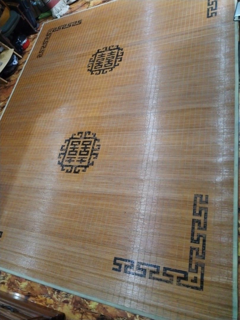 Traditional Asian bamboo sleeping mat with decorative border (Category: Carpets, Mats & Flooring) located in Caloocan City. Submitted by rowely_jpn (Listing ID 1470552597, Image 3). Description: Large bamboo cooling mat for the floor or bed. Smooth wooden slats tied together tightly. Features traditional Chinese geometric key borders and circular medallion patterns in black. Natural wood tones. Keeps cool during warm weather. Rolls up for easy st