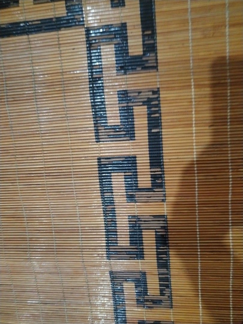 Traditional Asian bamboo sleeping mat with decorative border (Category: Carpets, Mats & Flooring) located in Caloocan City. Submitted by rowely_jpn (Listing ID 1470552597, Image 2). Description: Large bamboo cooling mat for the floor or bed. Smooth wooden slats tied together tightly. Features traditional Chinese geometric key borders and circular medallion patterns in black. Natural wood tones. Keeps cool during warm weather. Rolls up for easy st