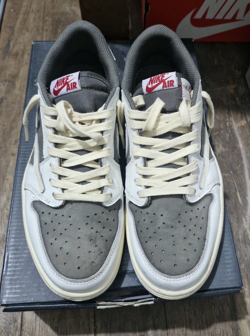 Travis Scott x Air Jordan 1 Low Reverse Mocha (Category: Sneakers) located in Manila. Submitted by blackstarharpoon (Listing ID 1470543357, Image 2). Description: - Travis Scott collaboration sneakers - Iconic reverse cream swoosh on the lateral side - Nike Air tongue tags in red and white with cream laces needs cleaning, active suede mid tier extra laces replacement box.