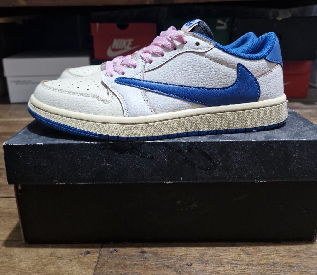 Travis Scott x Nike Air Jordan 1 Low (Category: Sneakers) located in Manila. Submitted by blackstarharpoon (Listing ID 1470526768, Image 1). Description: - Model: Travis Scott Collaboration Low-Top Sneakers - Upper: White tumbled leather - Distinctive Details: Royal blue reverse swooshes and bright pink laces - Interior & Sole: Blue inner lining with matching outsoles - Tongue: Exposed foam no box, replacement only extra laces mid tier.