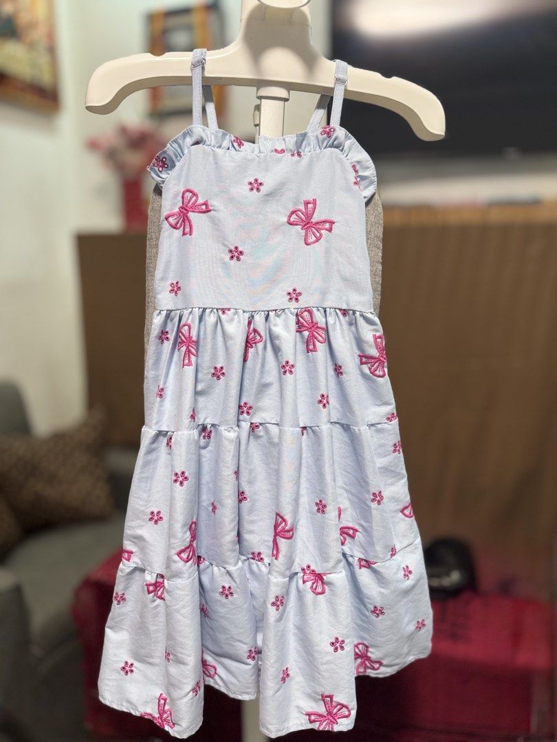 Twinning Dresses (Category: Babies & Kids Fashion) located in Mabalacat. Submitted by charm222 (Listing ID 1470507791, Image 2). Description: - Product: Twinning Dresses for Girls - Color: Light Blue with Pink Bow & Flower Embroidery - Design: Ruffle straps, square neckline, and tiered skirt - Size Range: Fits 4 to 13 years old - Condition: Excellent / Ready to wear - Perfect for: Matching outfits, parties, casual days, and special occasions 👗 2