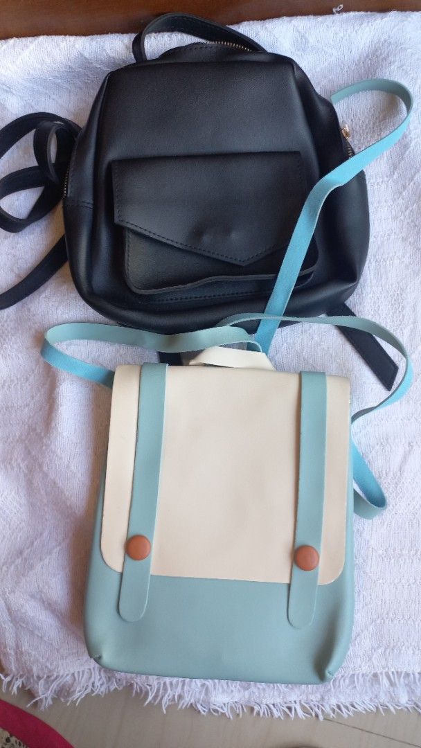 Two Mini Backpacks Set Black and Pastel Blue (Category: Backpacks) located in Rizal. Submitted by mayra74 (Listing ID 1470356547, Image 1). Description: - 2-in-1 Mini Backpack Bundle - Bag 1: Classic all-black design with a front flap pocket and secure zipper closure - Bag 2: Trendy pastel blue and cream colorway with stylish button snap accents and turquoise straps - Both bags feature comfortable, adjustable straps - Ideal everyday size for dail