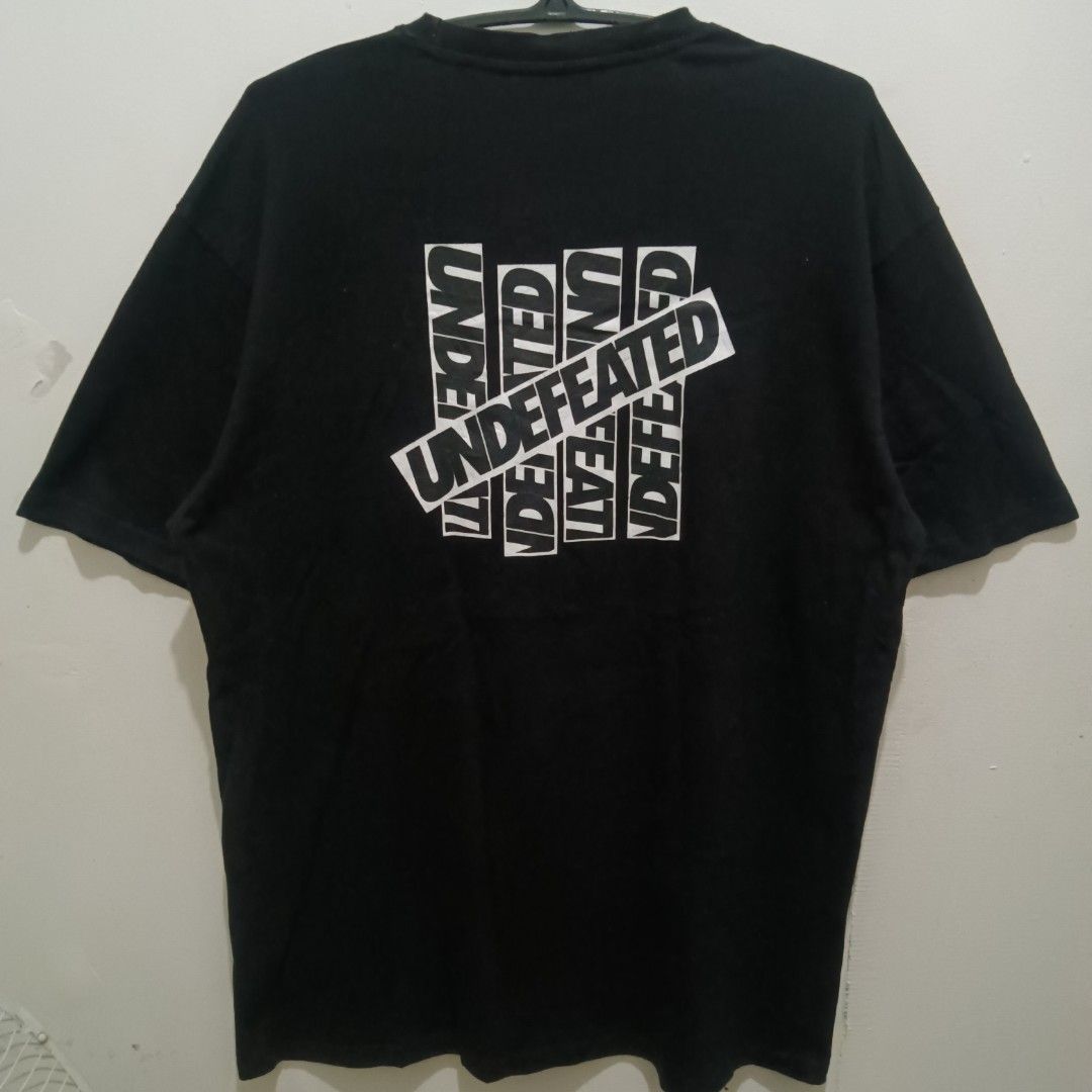 UNDEFEATED Graphic Black Shirt (Category: Tshirts & Polo Shirts ) located in Caloocan City. Submitted by jaychingsss (Listing ID 1470448896, Image 1). Description: Undefeated Graphic Shirt - 100 23x30 Color Rate: 9/10 Complete Tags Minor issue: may slight disco sa pinaka-tip ng neckline NEED WASH.
