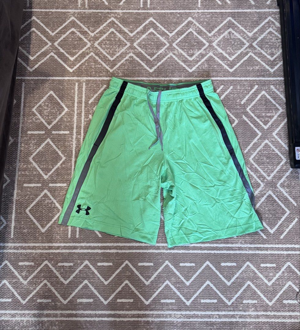 Under Armour Green Athletic Shorts Medium (Category: Shorts) located in Bulacan. Submitted by zyannechlo86360 (Listing ID 1470357297, Image 2). Description: - Brand: Under Armour - Color: Green with grey waistband and side stripes - Size: Medium - Features: Elastic waistband, adjustable drawstring, small logo on lower left leg - Material: Lightweight mesh - Ideal for: Workouts, running, and casual athletic wear 28-34 waist 19 length Excellent Loc