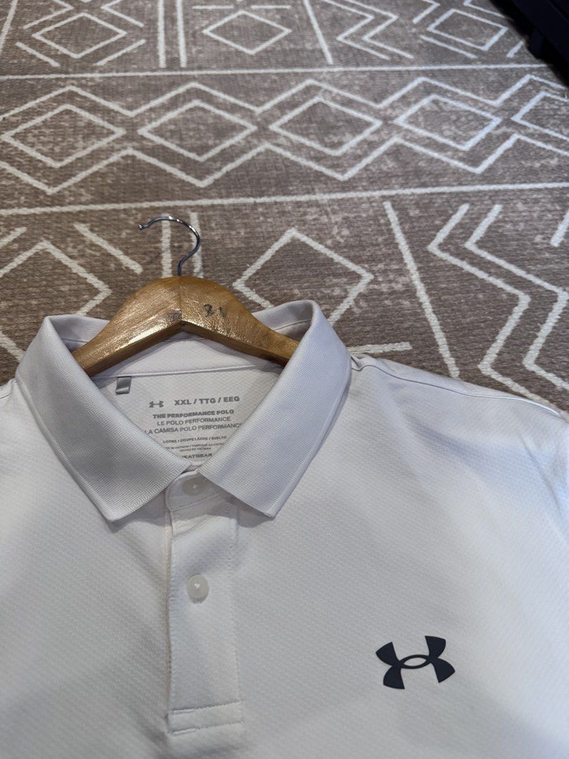 Under Armour The Performance Polo White XXL (Category: Tshirts & Polo Shirts ) located in Bulacan. Submitted by zyannechlo86360 (Listing ID 1470357878, Image 3). Description: - Brand: Under Armour - Model: The Performance Polo - Color: White - Size: XXL (Loose fit) - Fabric: Lightweight and breathable HeatGear - Details: Classic collared neckline with two-button placket, black UA logo on left chest and back collar - Origin: Made in Vietnam.