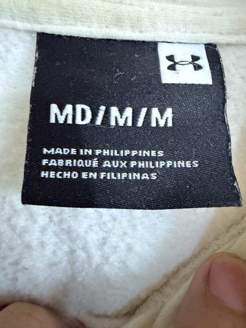 Under Armour White Hoodie Size Medium (Category: Hoodies) located in Manila. Submitted by snipe.shit (Listing ID 1470423970, Image 3). Description: - Brand: Under Armour - Color: White - Size: Medium (True to size) - Material: 80% cotton, 20% polyester (100% cotton hood lining) - Details: Box logo patch on left chest, adjustable drawstring hood, front kangaroo pocket - Origin: Made in Philippines - Condition: Clean, minimal streetwear staple for 