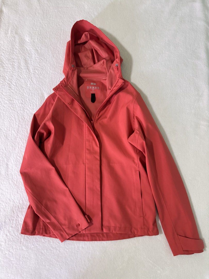 UNIQLO Blocktech Parka Size M (Category: Coats, Jackets and Outerwear) located in Manila. Submitted by mmilaomls (Listing ID 1470404335, Image 2). Description: - Brand: UNIQLO - Color: Red Orange - Size: Medium (M) - Features: Water resistant, windproof, durable water repellency, breathable, and stretch fabric - Design: Full front zip with snap button flap overlay, and adjustable hood with drawstrings and toggles - Condition: Clean inner lining a