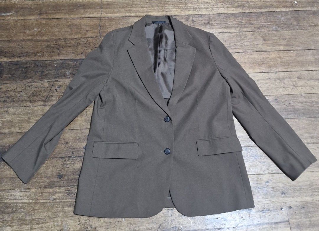 Uniqlo brown Two-Button Blazer Jacket (Category: Coats, Jackets and Outerwear) located in Manila. Submitted by blackstarharpoon (Listing ID 1470523731, Image 1). Description: - Color: Olive brown (Neutral earth tone) - Closure: Classic two-button front - Pockets: Two functional front flap pockets - Details: Structured lapels and smooth inner lining - Fit: Standard long sleeves with clean, quality stitching throughout - Style: Versatile and easy t