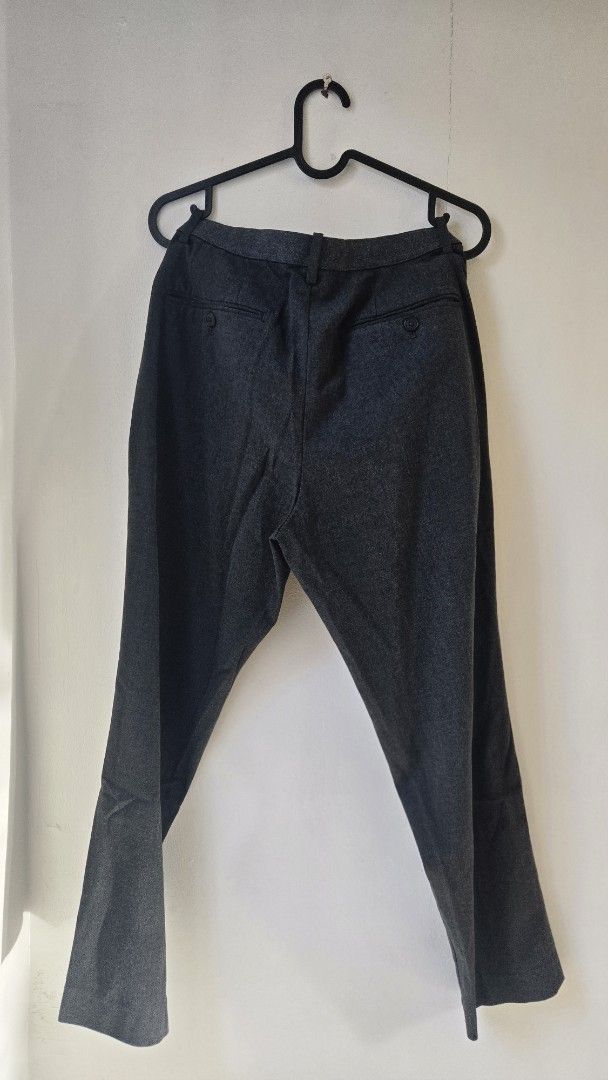 Uniqlo Dark Grey Smart Drawstring Trousers (Category: Trousers) located in General Trias. Submitted by gratsimaravilla (Listing ID 1470484689, Image 2). Description: - Color: Dark Grey - Style: Smart casual / Relaxed fit - Waist: Adjustable drawstring with zip fly and button closure - Pockets: Two back welt pockets with button details - Condition: Noticeable minor stitch fraying along the crotch seam (shown in closeups), but still very wearable f