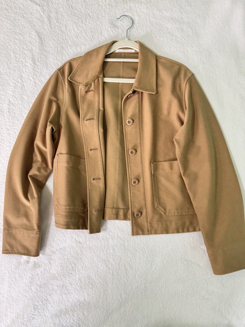 Uniqlo Jersey Short Jacket XS (Category: Coats, Jackets and Outerwear) located in Manila. Submitted by mmilaomls (Listing ID 1470411076, Image 3). Description: Uniqlo casual jacket in brown. Size XS. Material blend of polyester, cotton, and spandex. Button-up front with front pockets and buttoned cuffs. Simple collar and clean structured stitching throughout the back..
