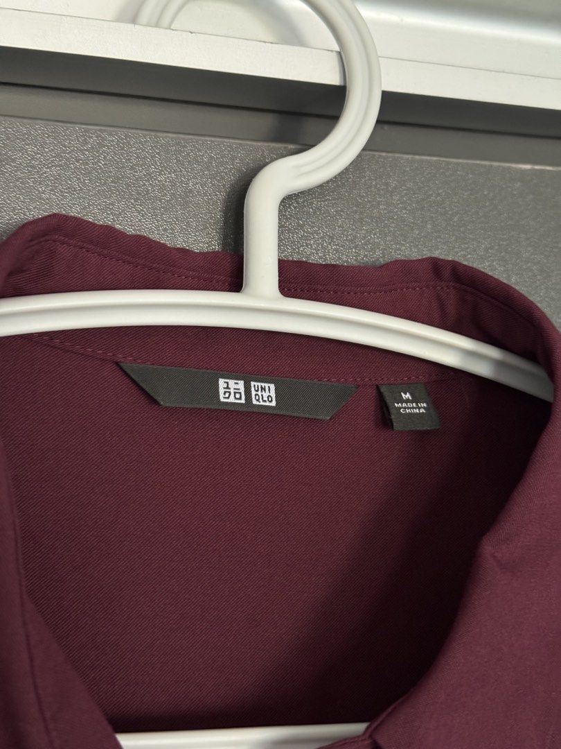 UNIQLO Long Sleeve Button Down Blouse Burgundy Size M (Category: Longsleeves) located in Dasmarinas. Submitted by akelvin23 (Listing ID 1470429921, Image 3). Description: - Brand: UNIQLO - Color: Deep burgundy - Size: M - Material: 76% rayon, 24% polyester blend - Design: Button-down front with matching buttons, classic collar, button cuffs, and elegant back pleat detail Width - 18.5 in Length - 26 in Shoulder - 15 in Sleeve - 21.5 in.