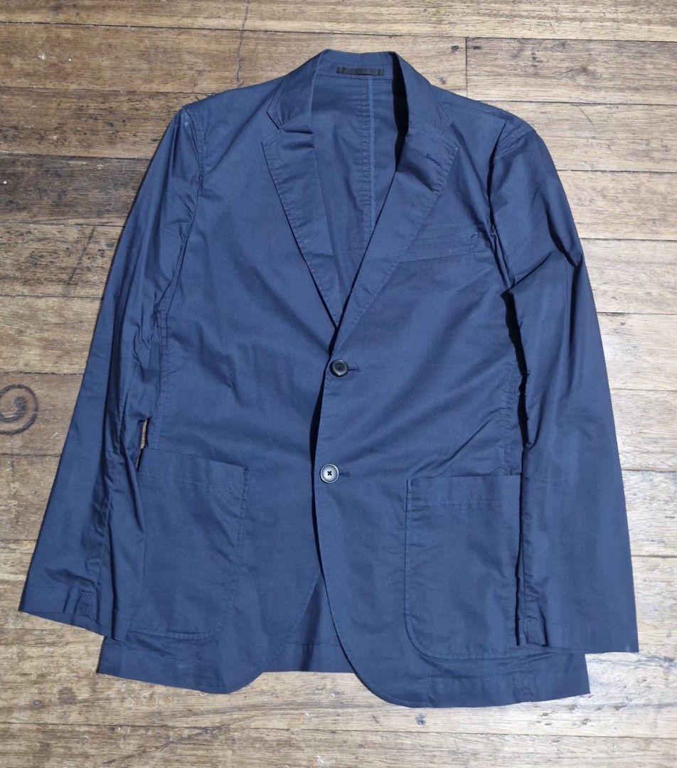 Uniqlo Navy Blue Casual Blazer Jacket (Category: Coats, Jackets and Outerwear) located in Manila. Submitted by blackstarharpoon (Listing ID 1470524654, Image 1). Description: - Color: Dark blue - Style: Smart casual lightweight blazer - Fit: Comfortable everyday fit with unstructured shoulders - Closure: Two front buttons - Pockets: Two large lower patch pockets and one chest pocket - Condition: Clean fabric, well-kept piece.
