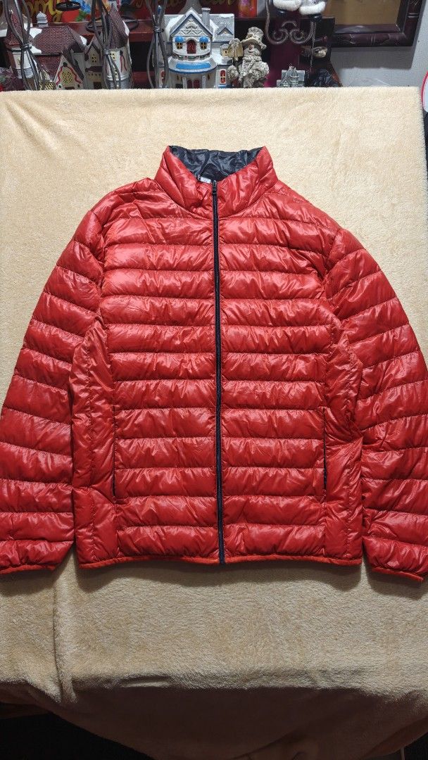 Uniqlo Red Down Jacket Puffer Coat (Category: Coats, Jackets and Outerwear) located in Manila. Submitted by bunnyf2600 (Listing ID 1470510417, Image 1). Description: - Authentic Uniqlo down jacket - Color: Bright red with dark navy lining - Material: 90% down and 10% feather filling for superior warmth - Super lightweight, compact, and easy to pack - Features a smooth zip-up front closure - Practical side zippered pockets to keep hands warm - Per