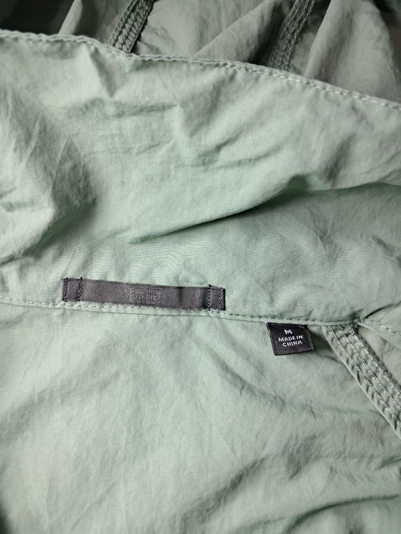 Uniqlo stand-collar blouson windbreaker jacket (Category: Coats, Jackets and Outerwear) located in Baguio. Submitted by mishmashfritz (Listing ID 1470466599, Image 3). Description: Like new, green, medium, no flaws, thrifted, needs wash, Water repellent material, stow-away hood.