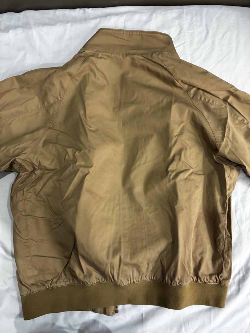 Uniqlo Tan Bomber Jacket with Plaid Lining (Category: Coats, Jackets and Outerwear) located in Manila. Submitted by nikkoour (Listing ID 1470408210, Image 2). Description: Negotiable - Color: Brown - Style: Zip-up bomber jacket with classic stand-up collar and button tab - Pockets: Two front welt pockets - Details: Stylish plaid inner lining, ribbed collar, cuffs, and hem - Condition: Casual outerwear piece with natural storage creases that need 