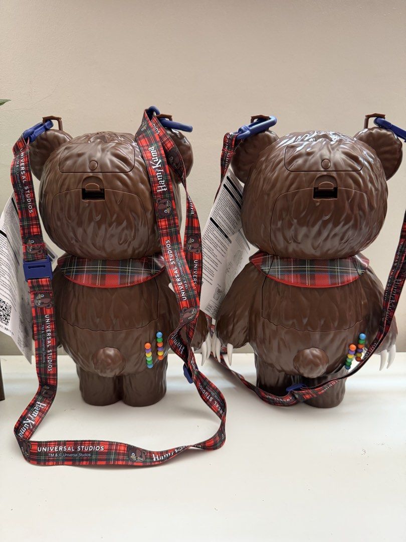 Universal Studios Japan Hami Kuma Bear Popcorn Bucket (Category: Character Goods) located in Bocaue. Submitted by arnssss (Listing ID 1470353107, Image 3). Description: - Authentic Universal Studios Japan exclusive Hami Kuma popcorn bucket - Creepy-cute brown fuzzy design with stitched details and a hanging eyeball spring - Complete with a stylish plaid collar and branded red tartan strap - Perfect for theme park trips or as a unique collection d